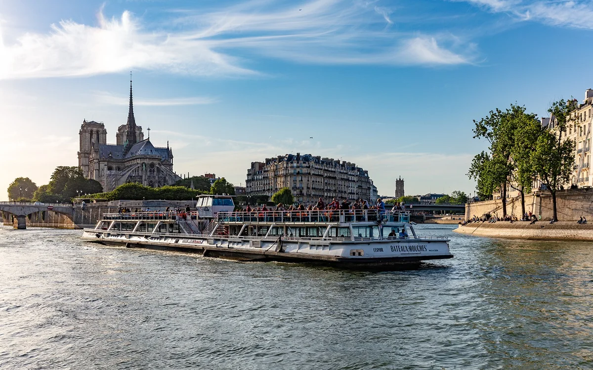 Sightseeing boat passing Notre Dame on the Seine