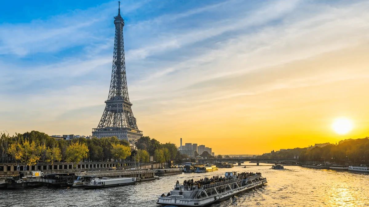 Sightseeing boat and Eiffel Tower at sunset