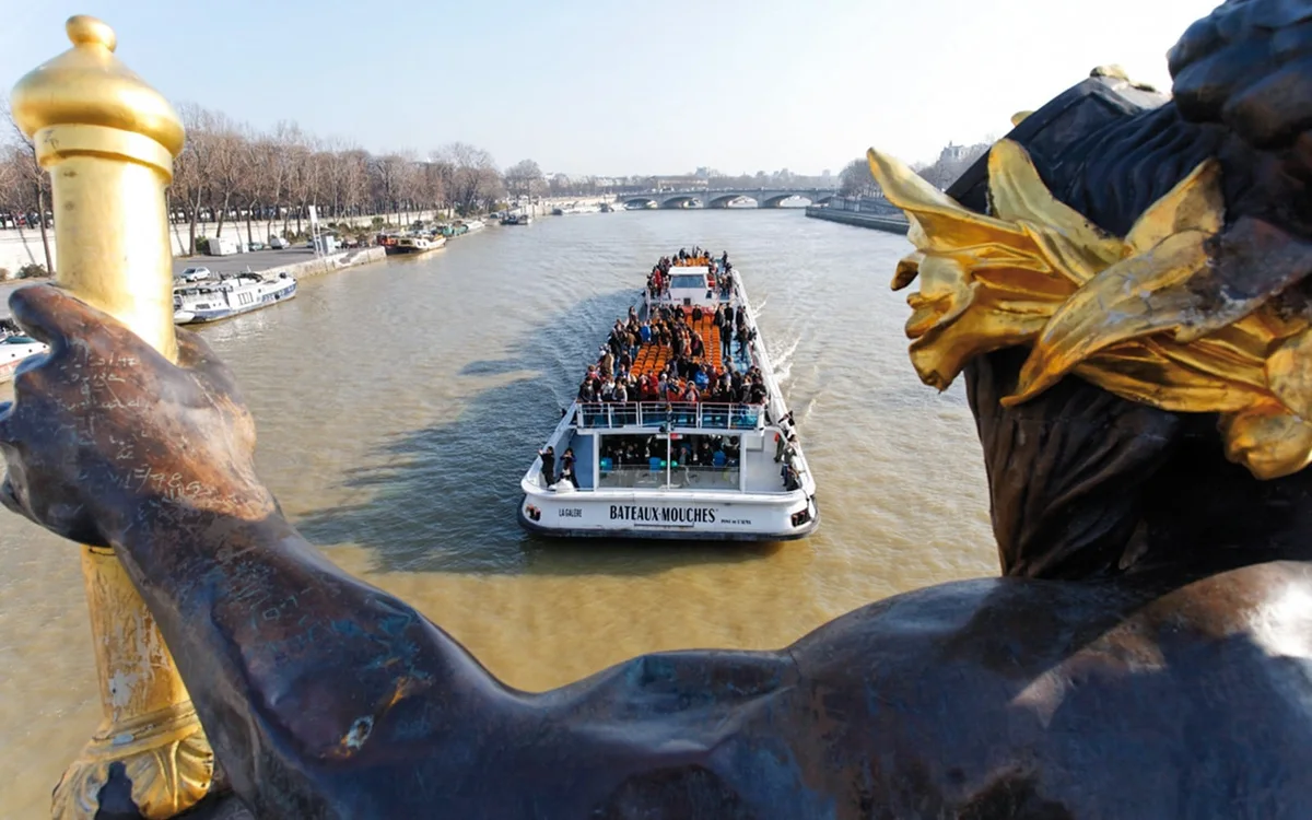 Bateaux Mouches boat viewed from a bridge over the Seine