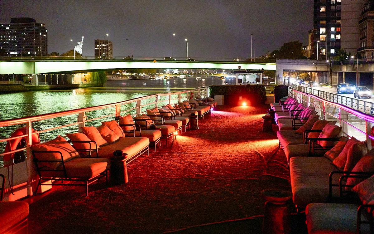 Seating on the open deck of the Théo boat at night