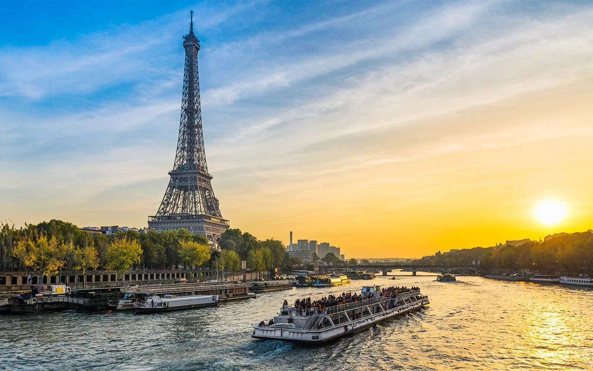 Seine sightseeing boat with the Eiffel Tower at sunset